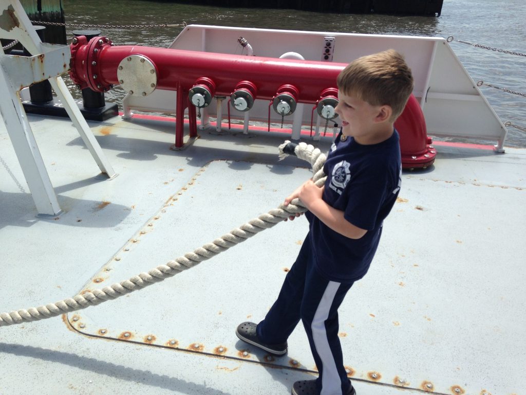 Edward pulls rope on the fire boat