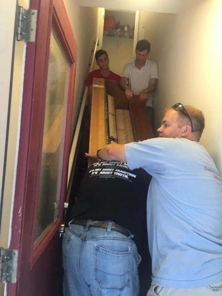 Sliding a piano down the stairs